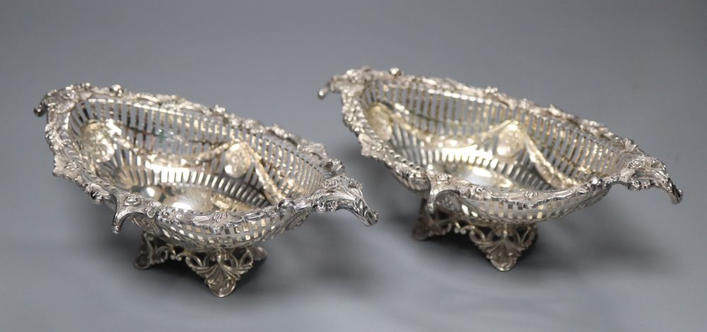 A pair Victorian pierced and cast silver oval bon bon dishes, London 1895, maker Thomas Bradbury, 19.2cm, 11oz.